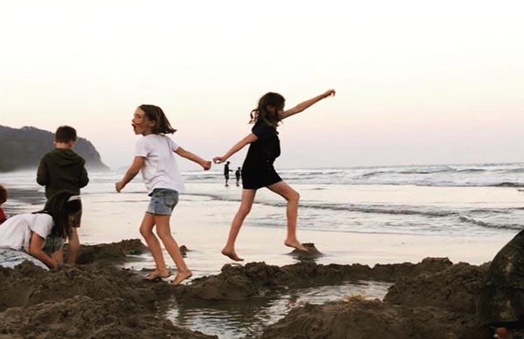 Kids playing at dusk on Opoutere Beach